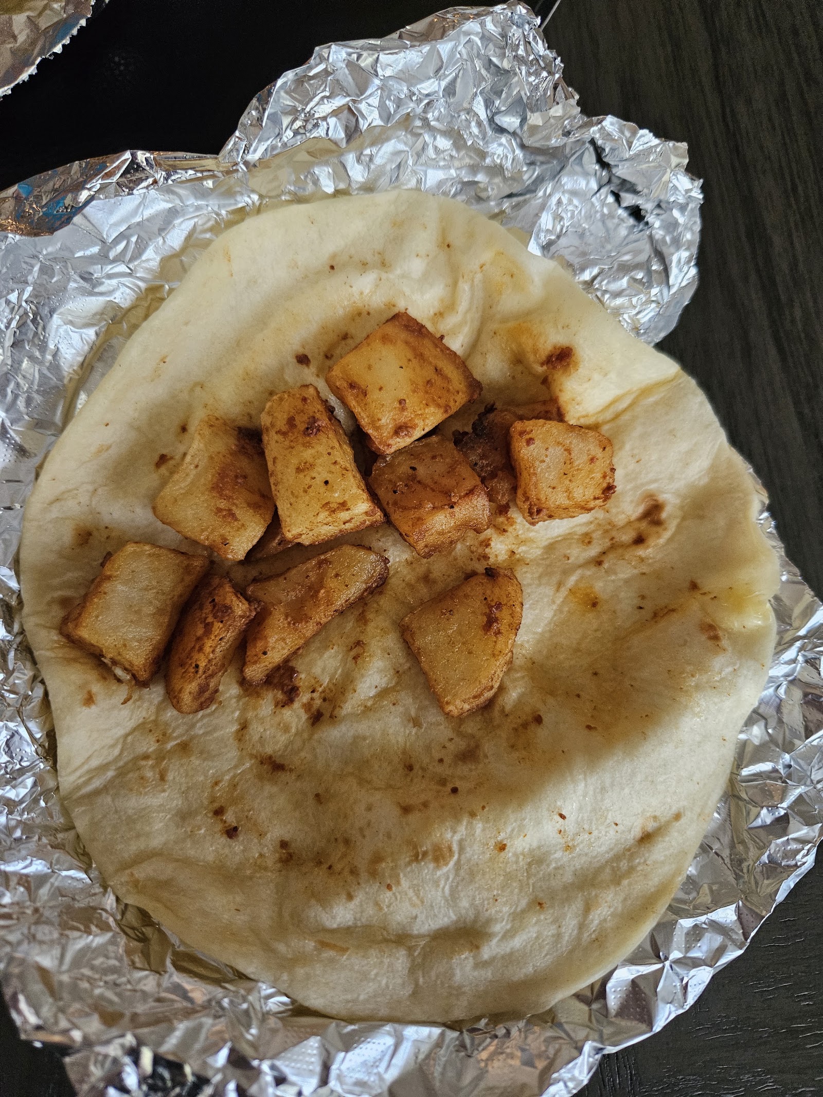 Breakfast taco with seasoned potatoes on a flour tortilla