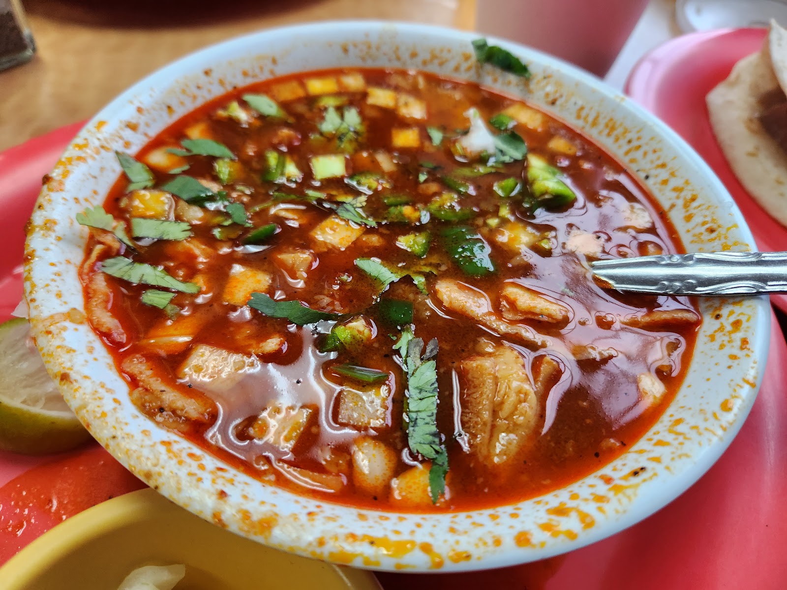 Bowl of traditional Mexican soup with fresh toppings